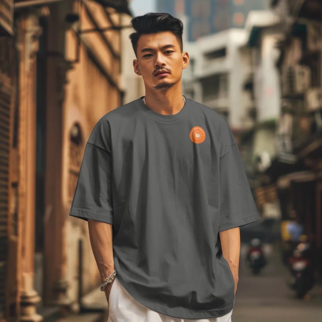 Man in a Pepper tee on a city street, with the small Cold Start Society logo on the left chest.