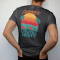 Man wearing a Black tee, seen from the back: a row of generic classic cars facing a striped retro sunset with palms and string lights, Summer in script over Cruise Night, in yellow, orange, red and teal.