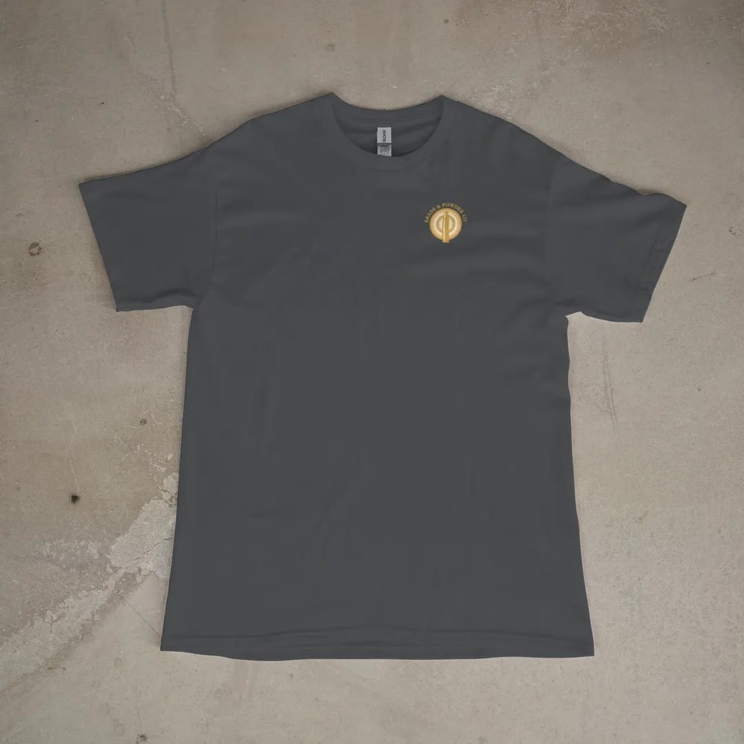 Front of a Graphite tee laid flat, with the small Brass & Powder Co. logo on the left chest.