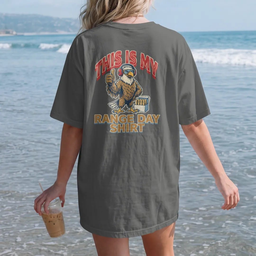 Woman on the beach in a Pepper tee, back view: a bald eagle mascot in ear protection and shooting glasses giving a thumbs up beside a box of brass, This Is My above and Range Day Shirt below.