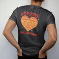 Man wearing a Black tee, seen from the back: a tattoo-flash heart made of stacked 9mm brass cartridges with sparkles, 9mm Is My Love Language lettering, in brass gold, red and cream.