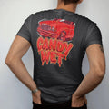 Man wearing a Black tee, seen from the back: glossy candy red paint dripping off a car hood with Candy Wet in big dripping letters, in red, silver, orange and lime.