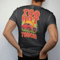 Man wearing a Black tee, seen from the back: a boxy 80s sedan on big chrome rims on shimmering hot asphalt under a blazing sun, with Too Hot over To Touch in flame-edged letters.