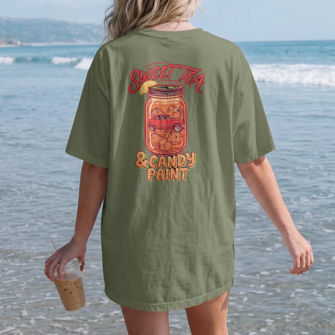 Woman on the beach in a Moss tee, back view: a mason jar of iced sweet tea reflecting a boxy sedan on big rims, with Sweet Tea in brush script over & Candy Paint in bubble letters.