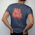 Man wearing a Navy tee, seen from the back: big sparkling metal-flake bubble letters reading All Flake over No Fake, with pinstripe swirls and sparkle stars.