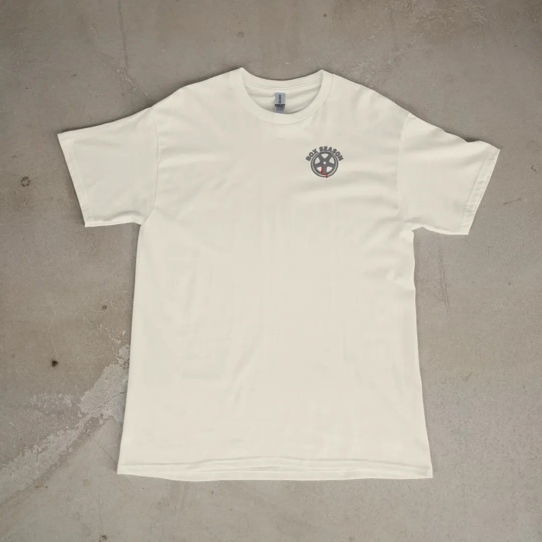 Front of a Ivory tee laid flat, with the small Box Season Customs logo on the left chest.