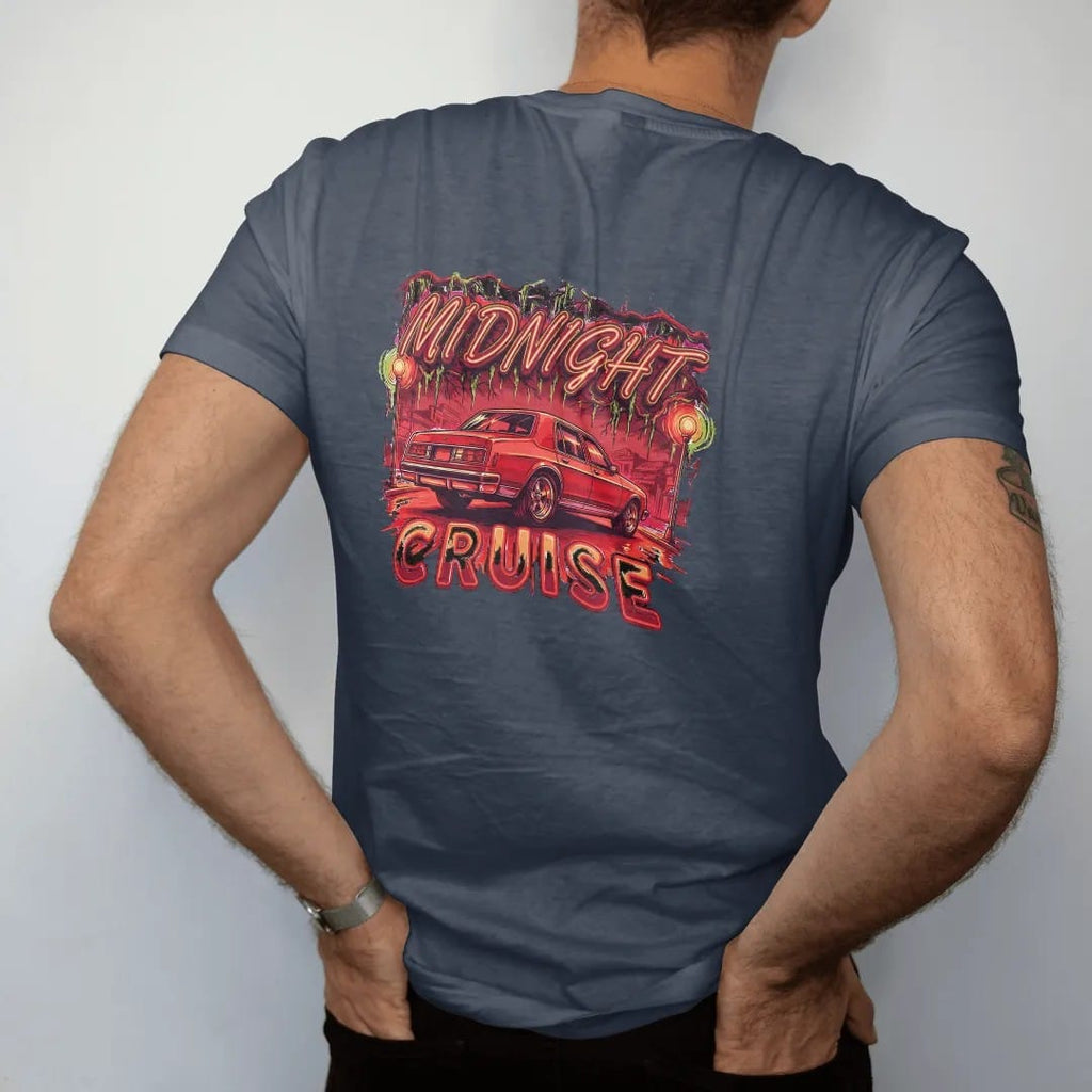 Man wearing a Midnight tee, seen from the back: a boxy sedan sitting high on chrome rims rolling under streetlights and mossy oaks with neon glow, under Midnight in neon script and over Cruise.