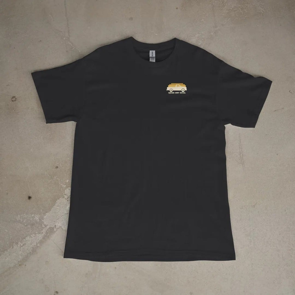 Front of a Black tee laid flat, with the small Square Body Social logo on the left chest.