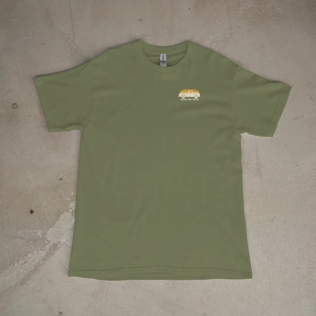 Front of a Moss tee laid flat, with the small Square Body Social logo on the left chest.