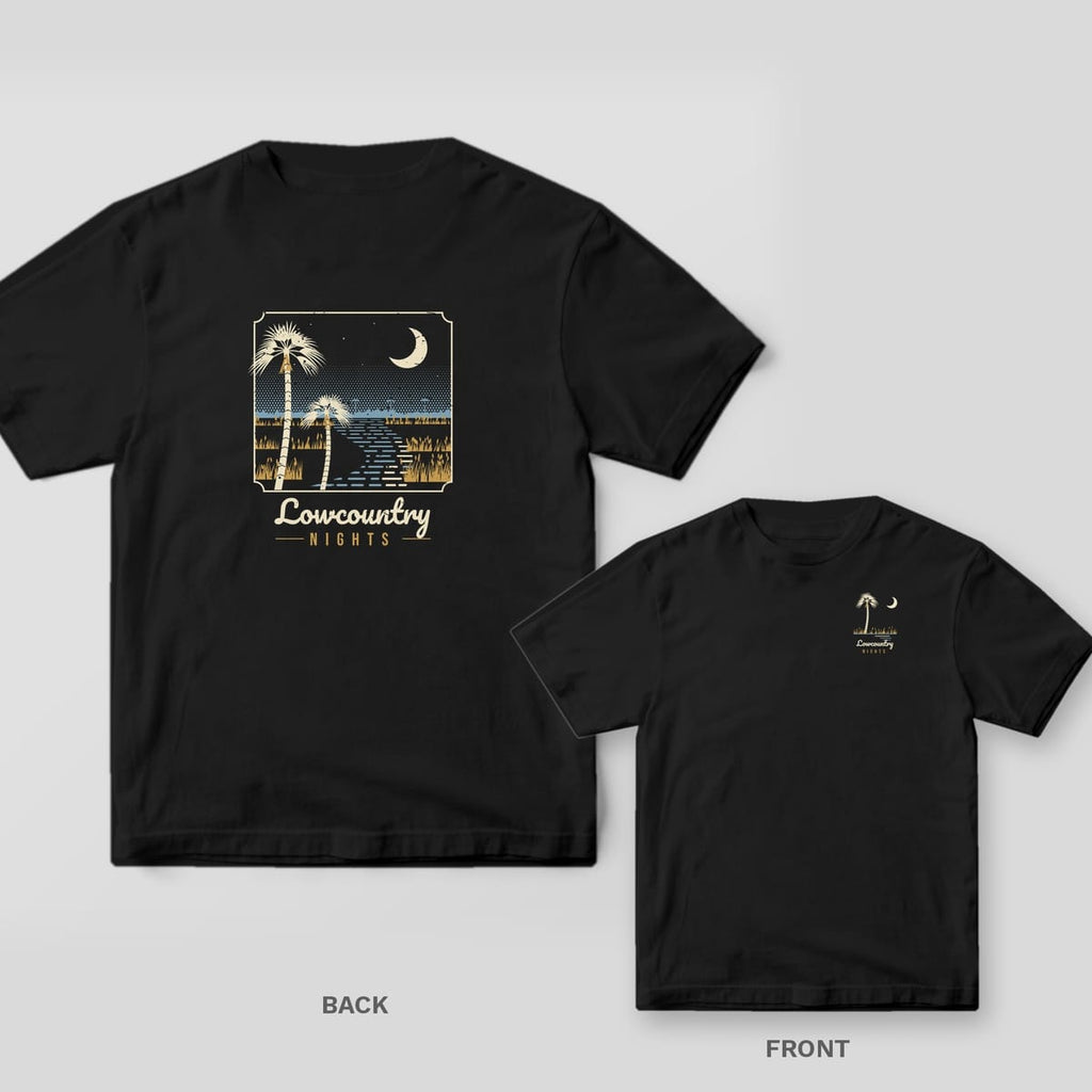 Black Comfort Colors tee shown back and front: a night marsh scene with palmettos and a crescent moon on the back and a small palmetto and moon on the left chest.
