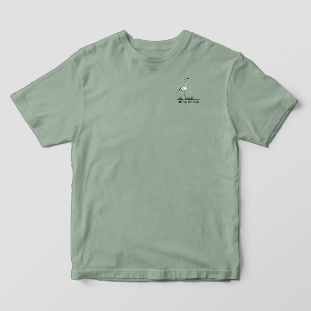 Front of a Bay Comfort Colors 1717 tee with a small left-chest egret standing in marsh grass above the words Marsh Air Club, Low Tide Is a Lifestyle.