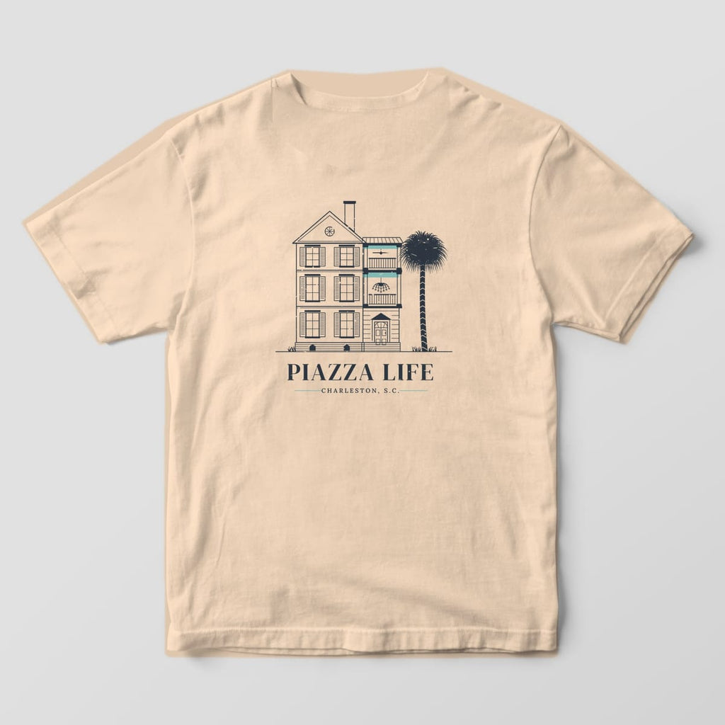 Back of a Ivory Comfort Colors 1717 tee with a charcoal line drawing of a Charleston single house with haint blue piazza ceilings above the words Piazza Life.