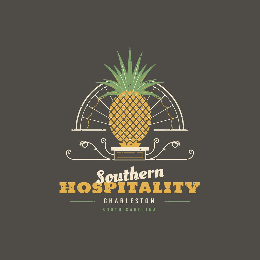 Close-up of the back print: crosshatched gold pineapple, green crown leaves, fanlight spokes and wrought-iron scrolls with a light worn texture.