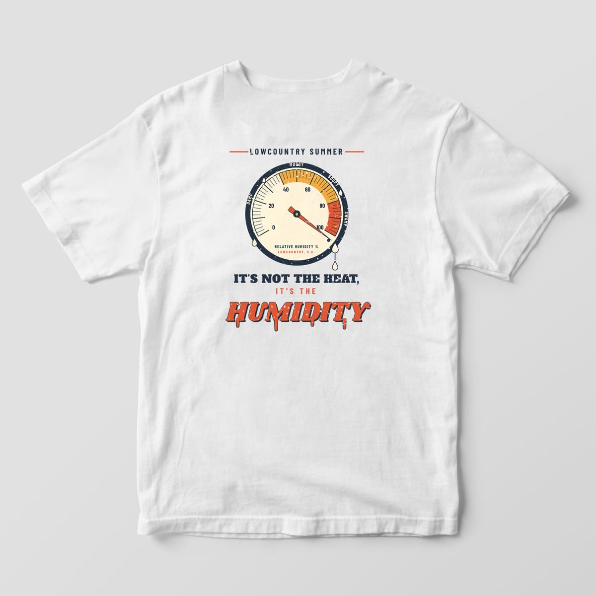 Back of a White Comfort Colors 1717 tee with a navy, red and mustard humidity dial pinned past 100 above the words It's not the heat, it's the humidity.