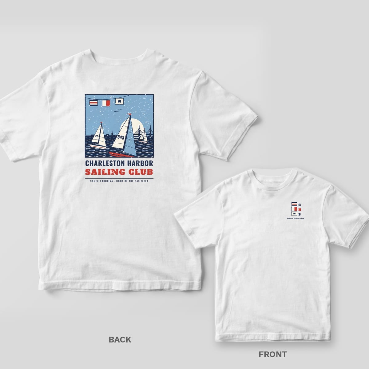White Comfort Colors tee shown back and front: a vintage regatta poster of sailboats on Charleston Harbor on the back and signal flags on the chest.