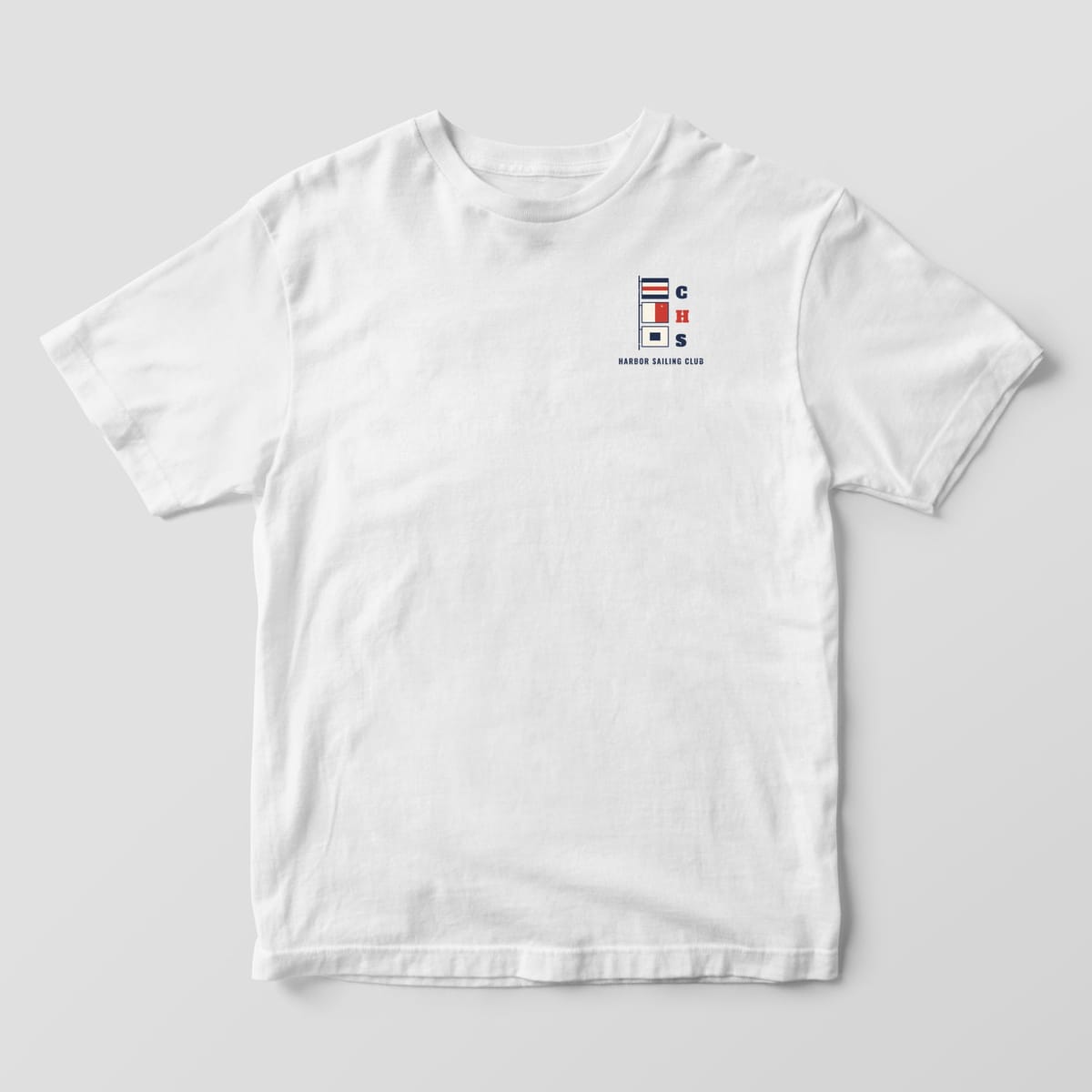Front of a White Comfort Colors 1717 tee with a small left-chest stack of C, H and S signal flags.