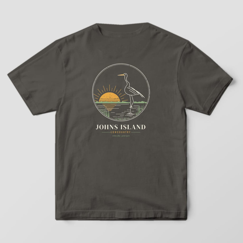 Back of a Pepper Comfort Colors 1717 tee with a cream line drawing of a great egret wading at a gold sunrise above the words Johns Island, Lowcountry.