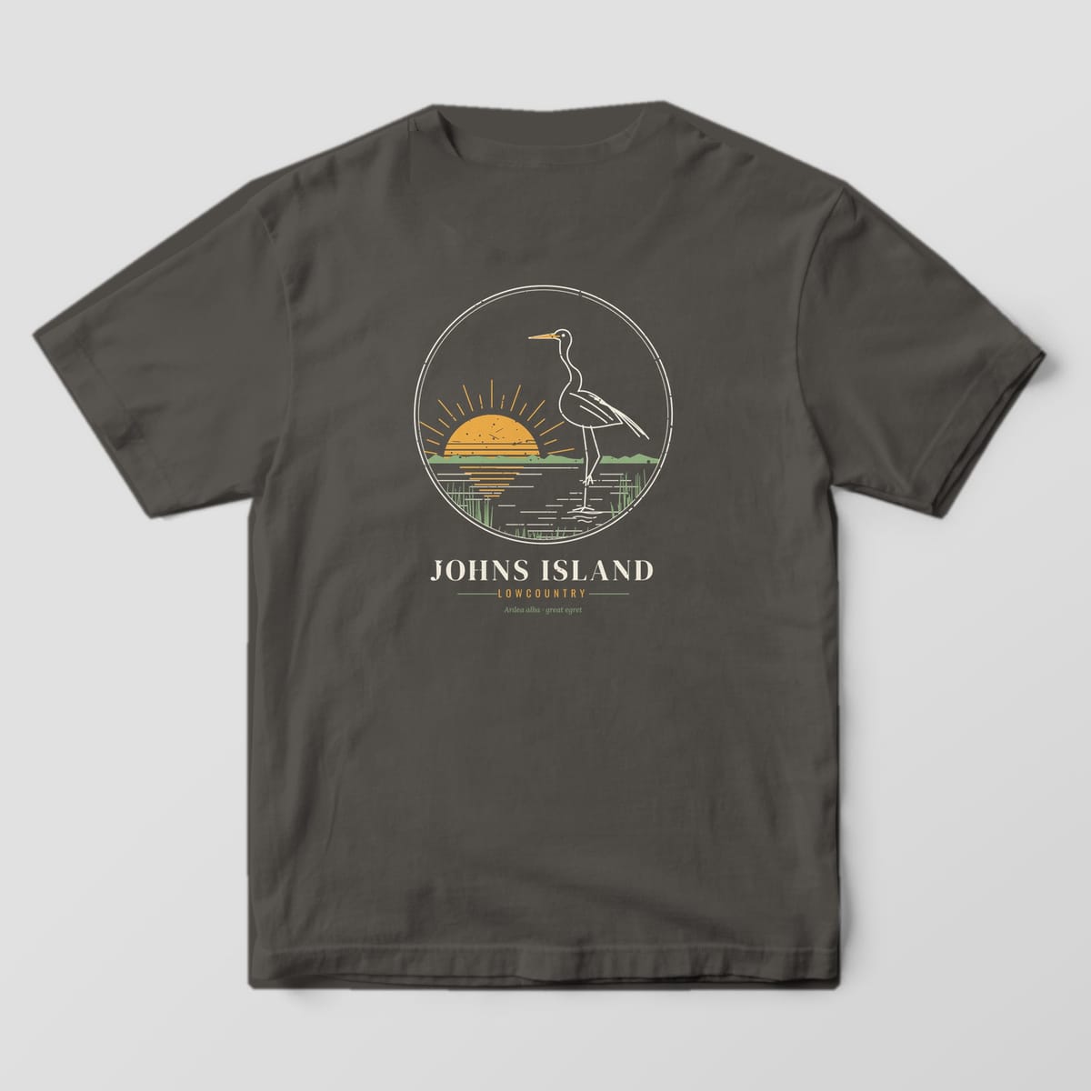 Back of a Pepper Comfort Colors 1717 tee with a cream line drawing of a great egret wading at a gold sunrise above the words Johns Island, Lowcountry.