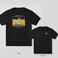 Black Comfort Colors tee shown back and front: a kayaker in a marsh creek at sunset on the back and a small kayak mark on the chest.