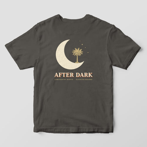 Back of a Pepper Comfort Colors 1717 tee with a large cream crescent moon cradling a gold palmetto tree with four small stars, above AFTER DARK and LOWCOUNTRY NIGHTS · ELEVATED DESIGNS.