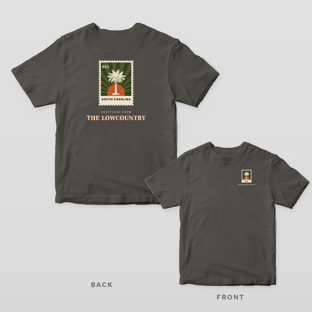 Pepper Comfort Colors tee shown back and front: a vintage palmetto postage stamp over GREETINGS FROM THE LOWCOUNTRY on the back and a small stamp on the left chest.