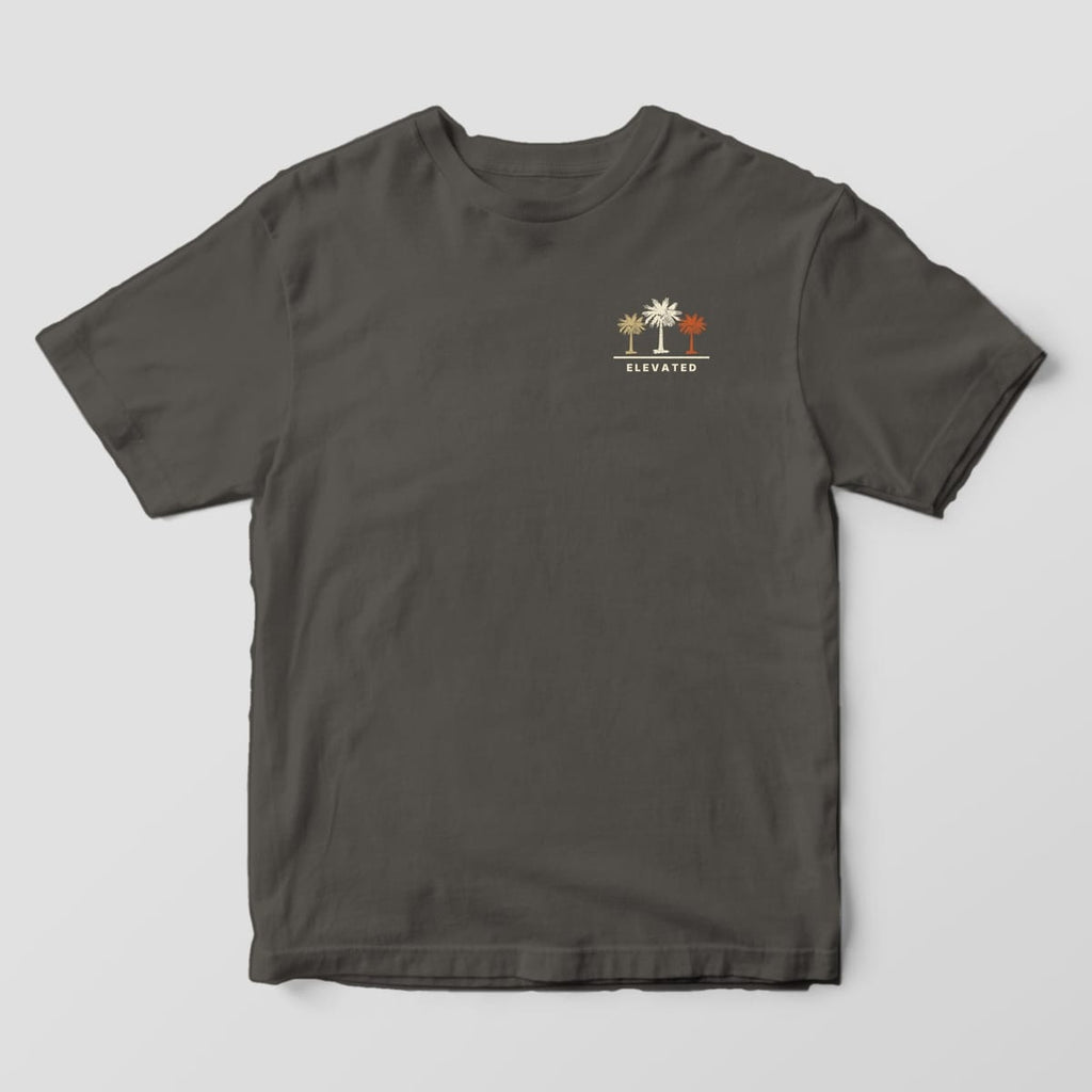 Front of a Pepper Comfort Colors 1717 tee with a small left-chest row of three palmettos in tan, cream and rust above the word ELEVATED.