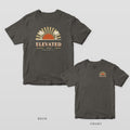 Pepper Comfort Colors tee shown back and front: a retro sunburst with two palmettos over ELEVATED on the back and a small sunburst over ELEVATED on the left chest.