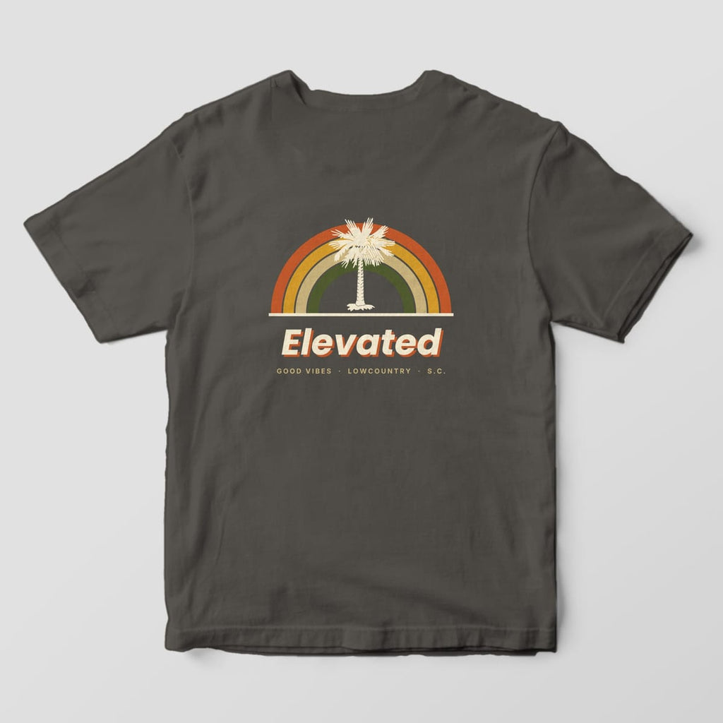 Back of a Pepper Comfort Colors 1717 tee with four retro rainbow arcs in rust, gold, tan and olive around a cream palmetto tree, above Elevated and GOOD VIBES · LOWCOUNTRY · S.C.