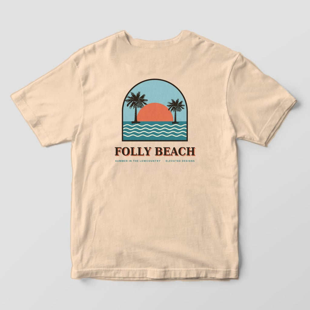 Back of an Ivory Comfort Colors 1717 tee with an arched beach scene of two palmettos, a coral sun and teal ocean waves under a light blue sky, above FOLLY BEACH and SUMMER IN THE LOWCOUNTRY · ELEVATED DESIGNS.