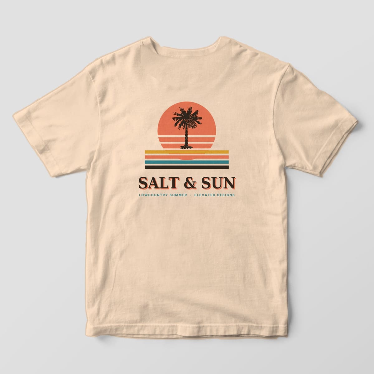 Back of an Ivory Comfort Colors 1717 tee with a dark palmetto in front of a striped coral sun over gold, coral, teal and brown stripes, above SALT & SUN and LOWCOUNTRY SUMMER · ELEVATED DESIGNS.