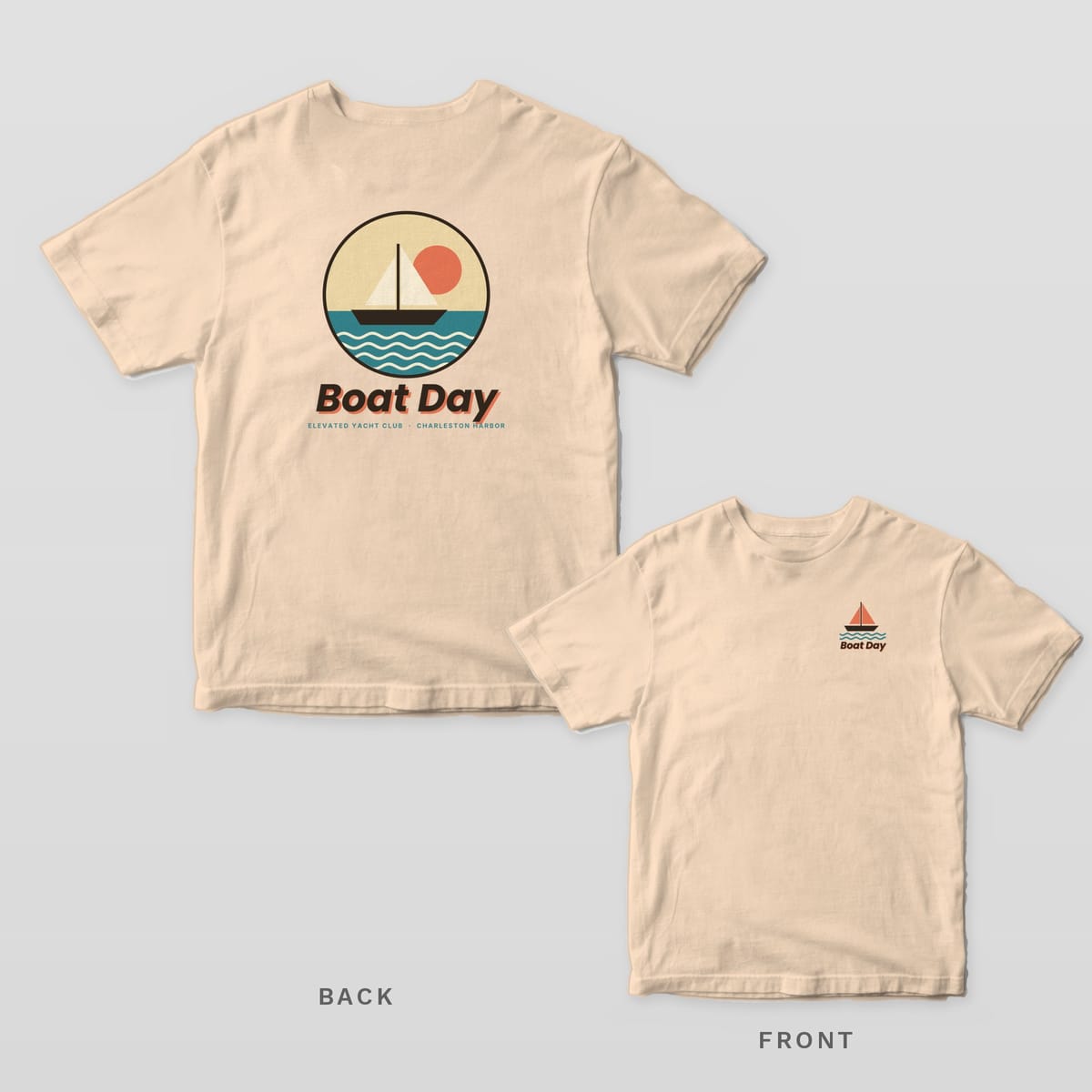 Ivory Comfort Colors tee shown back and front: a round sailboat badge over Boat Day on the back and a small coral sailboat over Boat Day on the left chest.