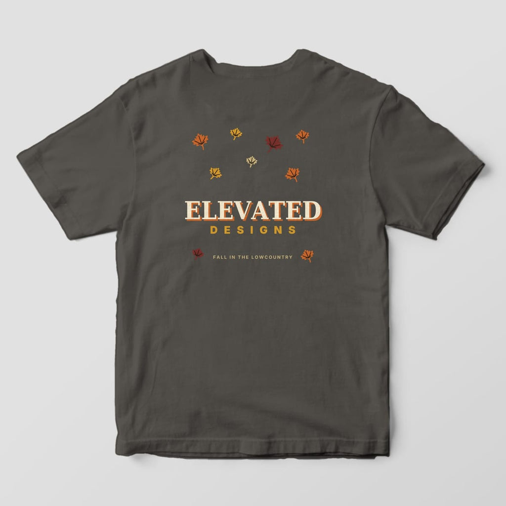 Back of a Pepper Comfort Colors 1717 tee with scattered maple leaves in rust, gold, maroon and tan around ELEVATED DESIGNS and FALL IN THE LOWCOUNTRY.