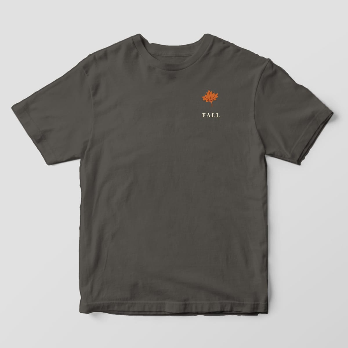 Front of a Pepper Comfort Colors 1717 tee with a small left-chest rust maple leaf above the word FALL.