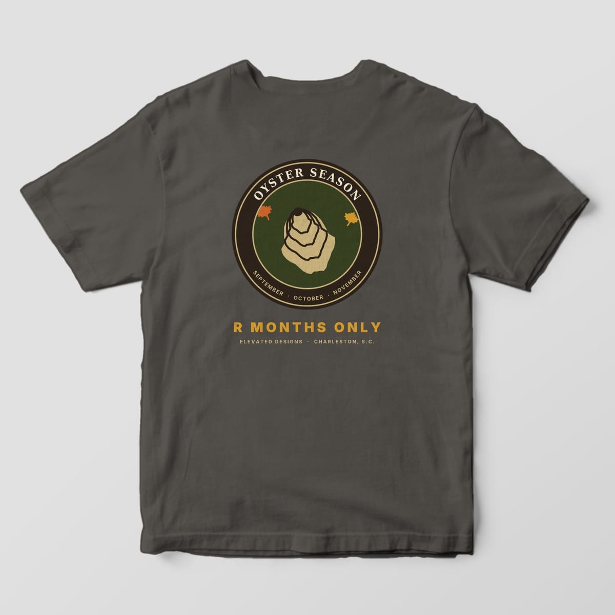 Back of a Pepper Comfort Colors 1717 tee with a round OYSTER SEASON badge with a tan oyster and two autumn leaves on olive, reading SEPTEMBER · OCTOBER · NOVEMBER, above R MONTHS ONLY.