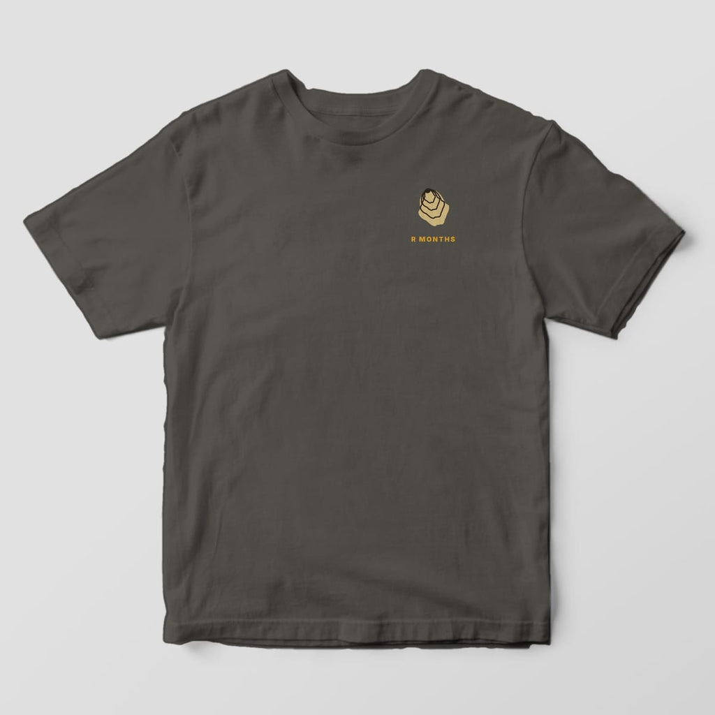 Front of a Pepper Comfort Colors 1717 tee with a small left-chest tan oyster shell above the words R MONTHS.