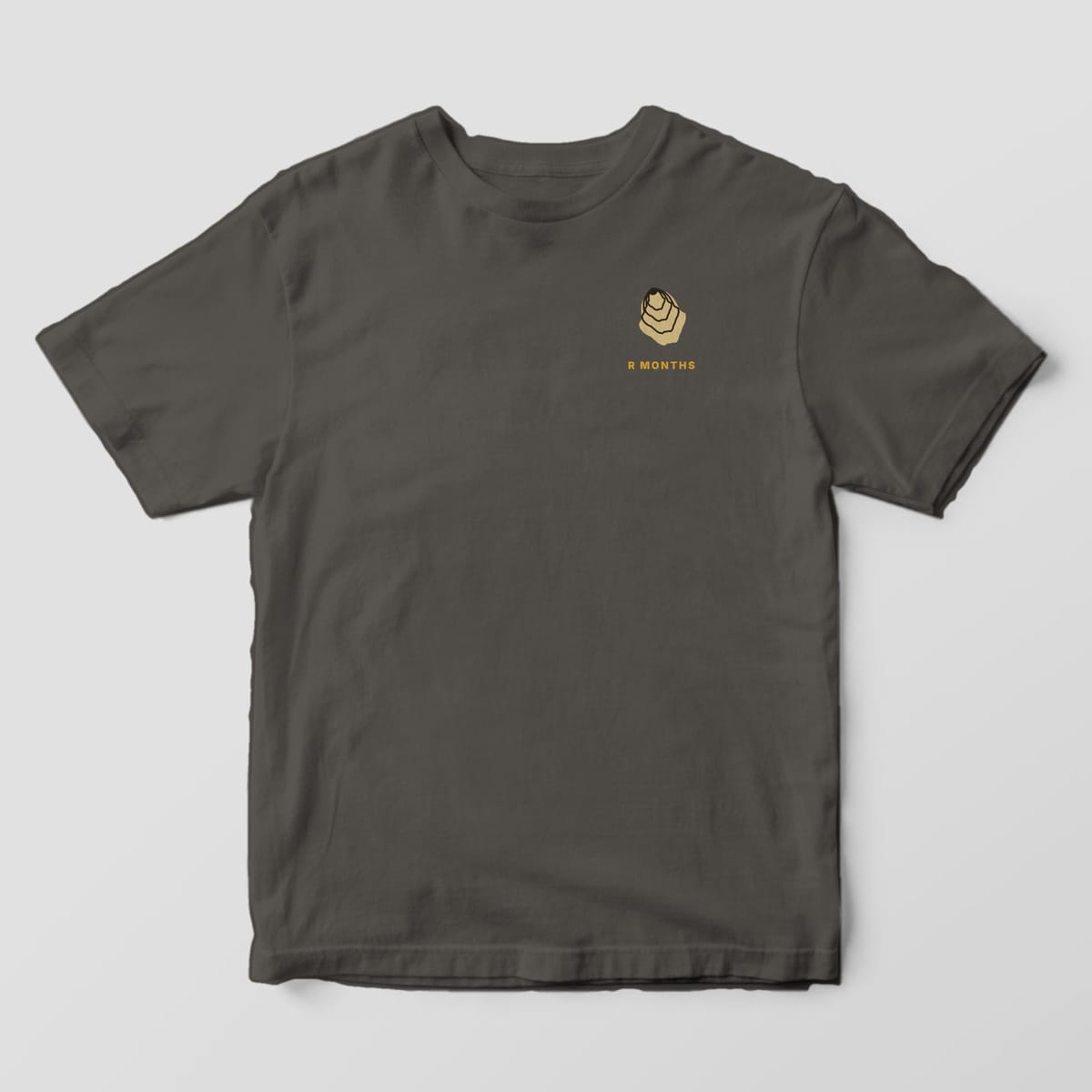 Front of a Pepper Comfort Colors 1717 tee with a small left-chest tan oyster shell above the words R MONTHS.