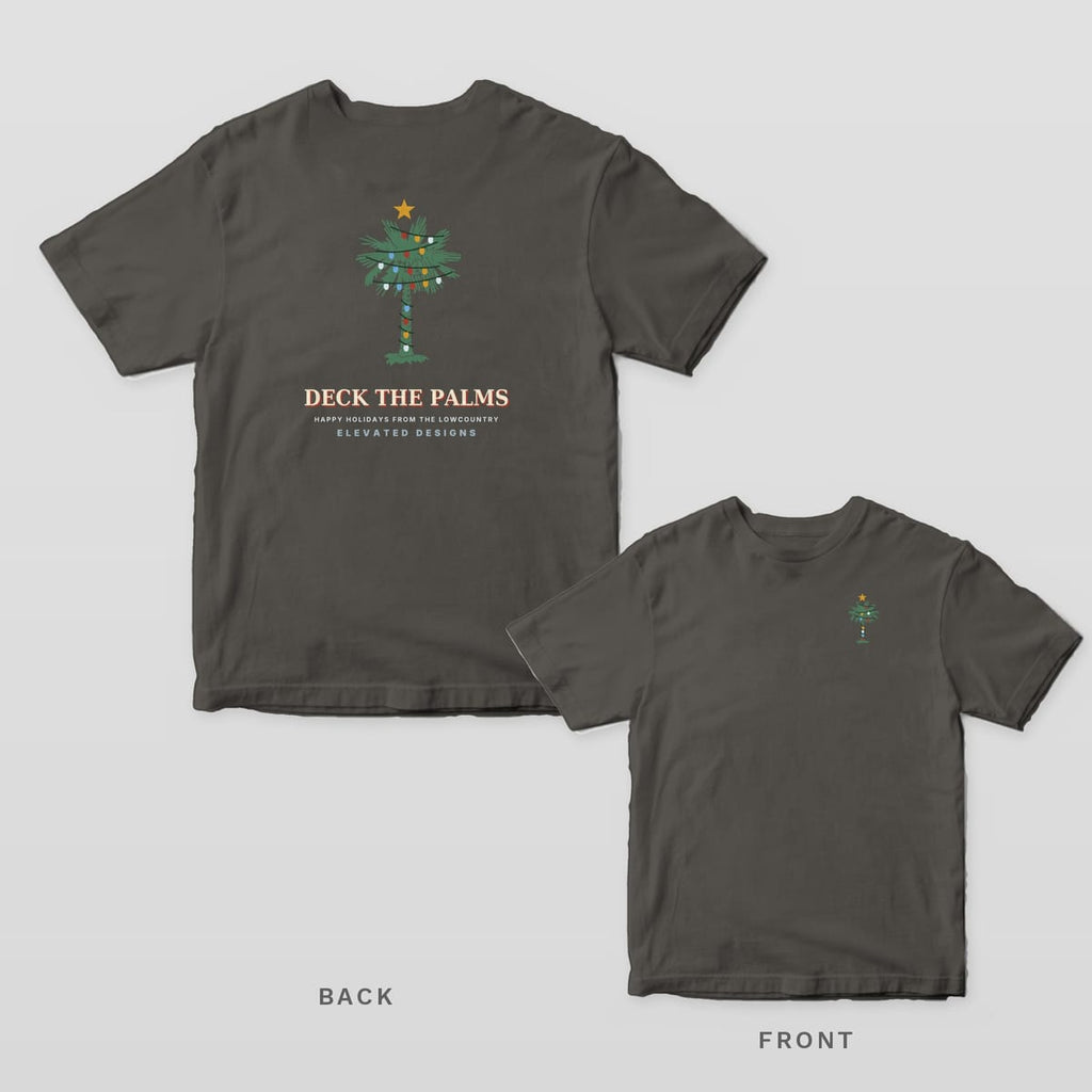 Pepper Comfort Colors tee shown back and front: a palmetto wrapped in Christmas lights over DECK THE PALMS on the back and a smaller lit palmetto on the left chest.