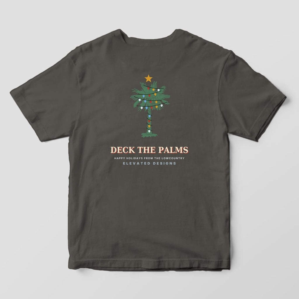 Back of a Pepper Comfort Colors 1717 tee with a green palmetto wrapped in red, gold, blue and white Christmas lights with a gold star on top, above DECK THE PALMS and HAPPY HOLIDAYS FROM THE LOWCOUNTRY.