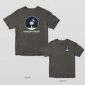 Pepper Comfort Colors tee shown back and front: a round winter night scene with a palmetto and pines over LONGEST NIGHT on the back and a small round night scene on the left chest.