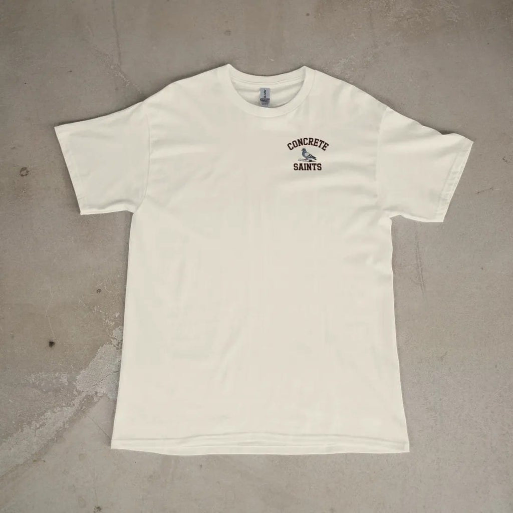 Front of a Ivory tee laid flat, with the small Concrete Saints logo on the left chest.