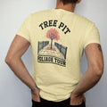 Man wearing a Butter tee, seen from the back: a single sidewalk tree in a fenced pit dropping orange leaves, under Tree Pit and over Foliage Tour, in charcoal, brick red, green and navy.