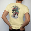 Man wearing a Butter tee, seen from the back: a fire escape crowded with potted tomatoes and herbs under Fire Escape and over a Garden Club banner, in charcoal, brick red, green and navy.
