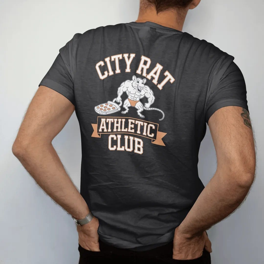 Man wearing a Black tee, seen from the back: a muscular cartoon rat hauling a pizza crust under City Rat arched over an Athletic Club ribbon, in bone white, orange, yellow and green.