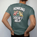 Man wearing a Blue Spruce tee, seen from the back: a cartoon traffic jam of taxis and buses with horn bursts under Honking and calm Doesn't Help lettering, in yellow, orange, bone white and green.