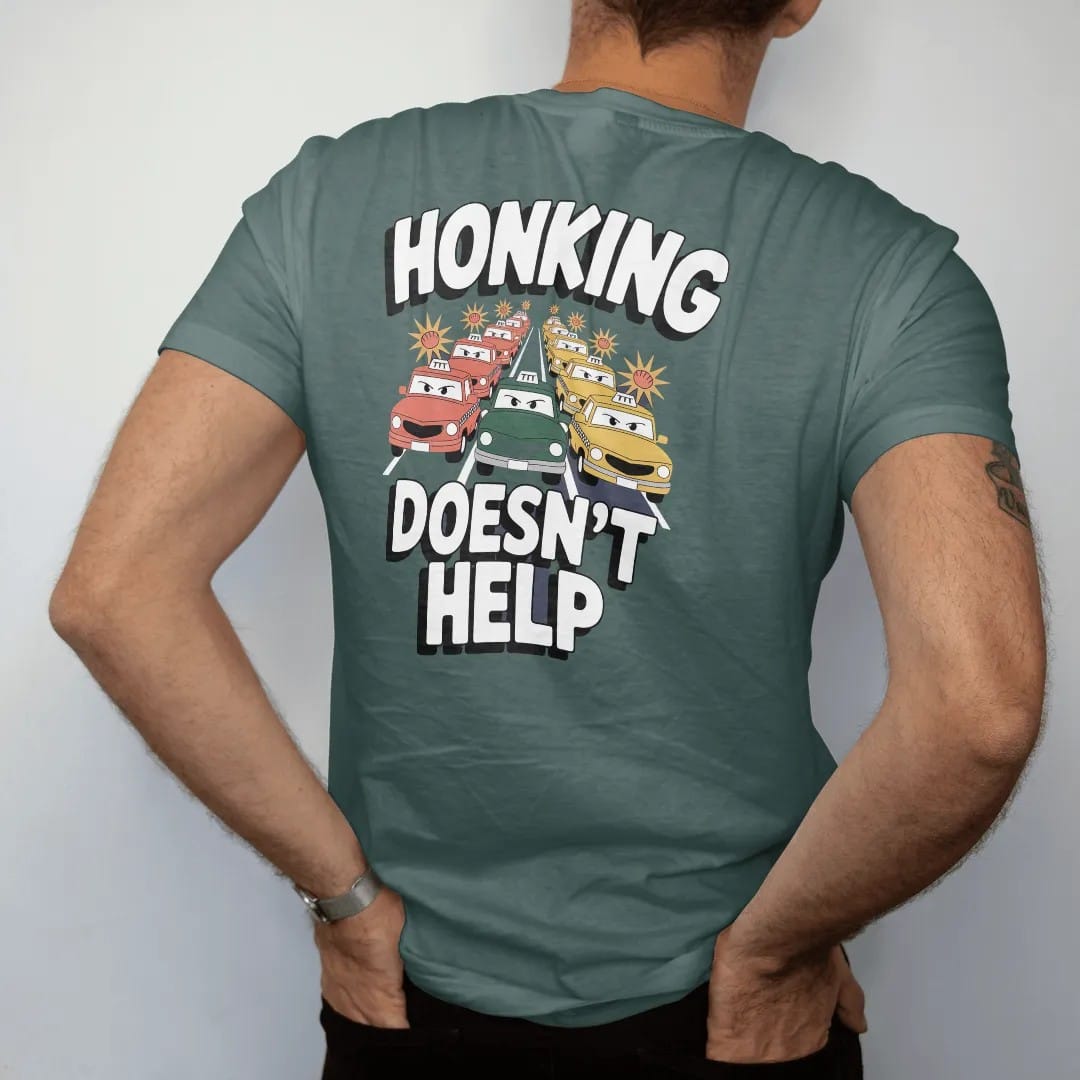 Man wearing a Blue Spruce tee, seen from the back: a cartoon traffic jam of taxis and buses with horn bursts under Honking and calm Doesn't Help lettering, in yellow, orange, bone white and green.