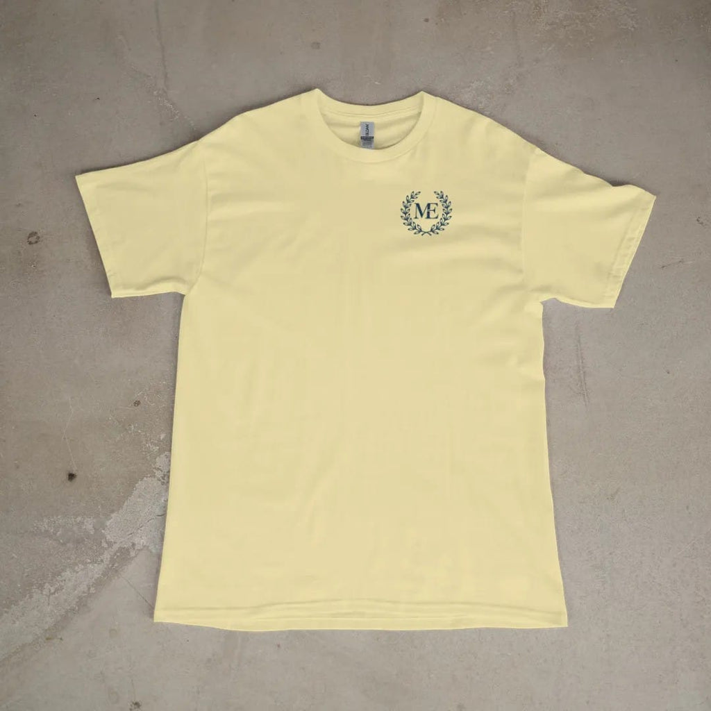 Front of a Butter tee laid flat, with the small Maison Elevé logo on the left chest.