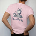 Man wearing a Blossom tee, seen from the back: a porcelain teapot pouring into a cup beside a tiered cake tray with Tea At Four, as a fine engraving in navy and antique gold.