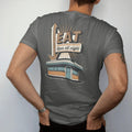 Man wearing a Pepper tee, seen from the back: a tall vertical diner sign with a bulb-lit arrow over a chrome roofline, with "EAT" and "OPEN ALL NIGHT" in chunky 70s lettering and brush script, printed in faded, cracked cream, mustard, burnt orange…