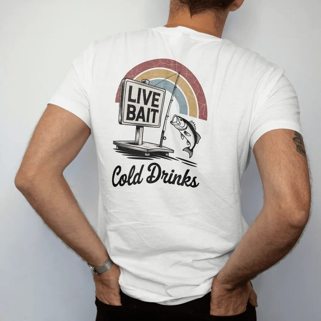 Man wearing a White tee, seen from the back: a weathered bait-shop sign with a bobber, fishing pole and jumping bass, with "LIVE BAIT" and "COLD DRINKS" in chunky 70s lettering and brush script, printed in faded, cracked brown, rust red, mustard…
