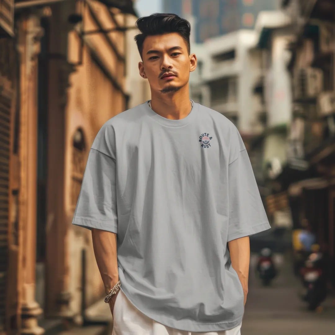 Man in a Granite tee on a city street, with the small Route & Rust logo on the left chest.